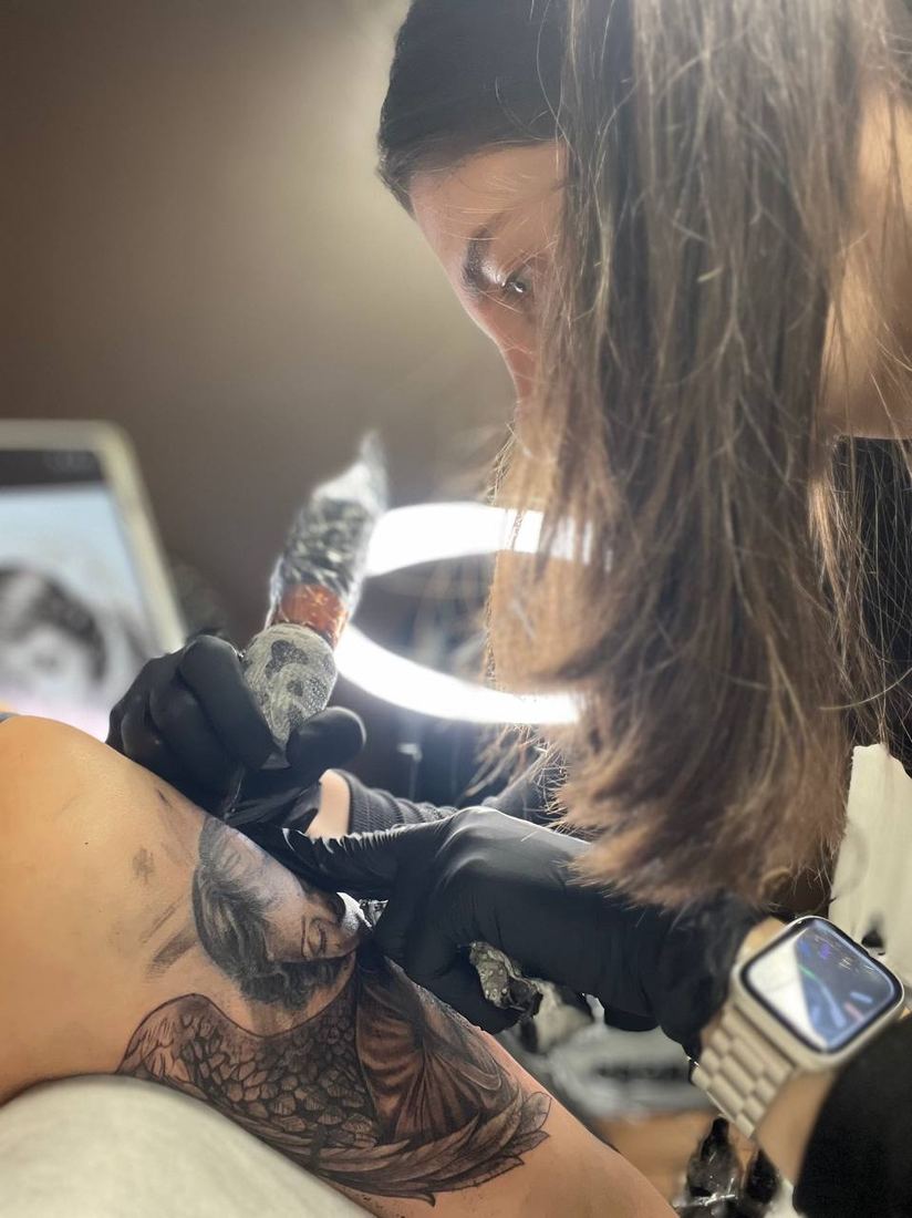 Ladygina at work on a tattoo